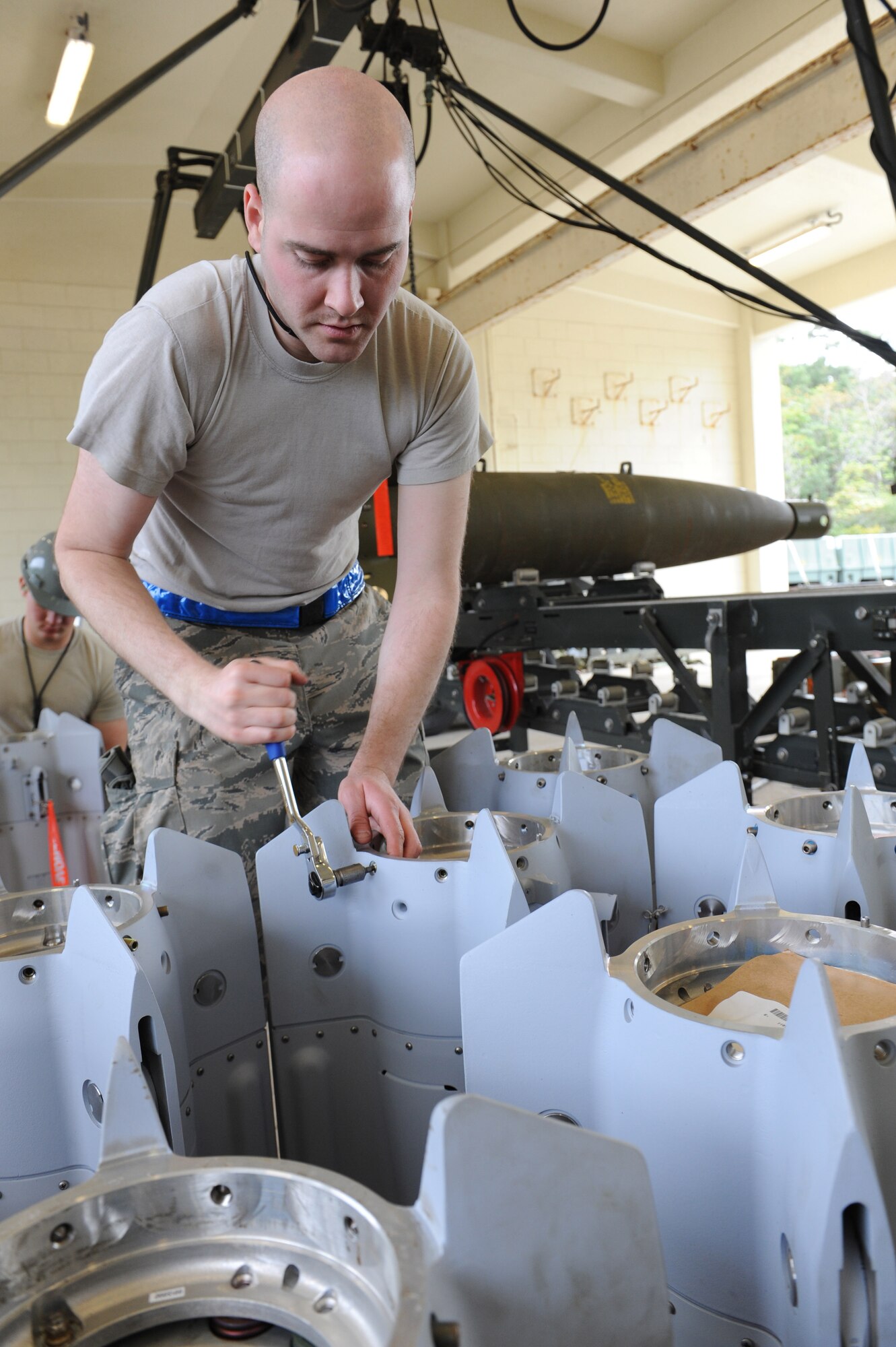 U.S. Air Force Staff Sgt. Michael Burdge, 3rd Munitions Squadron precision guided missile crew chief, loosens screws for a guided bomb unit 12 bomb during a combat ammunition production exercise on Kadena Air Base, Japan, March 5, 2013. The exercise is a Pacific Air Forces exercise held annually to test the munitions Airmen’s ability to build ammunition for wartime aircraft. (U.S. Air Force photo/Airman 1st Class Malia Jenkins)