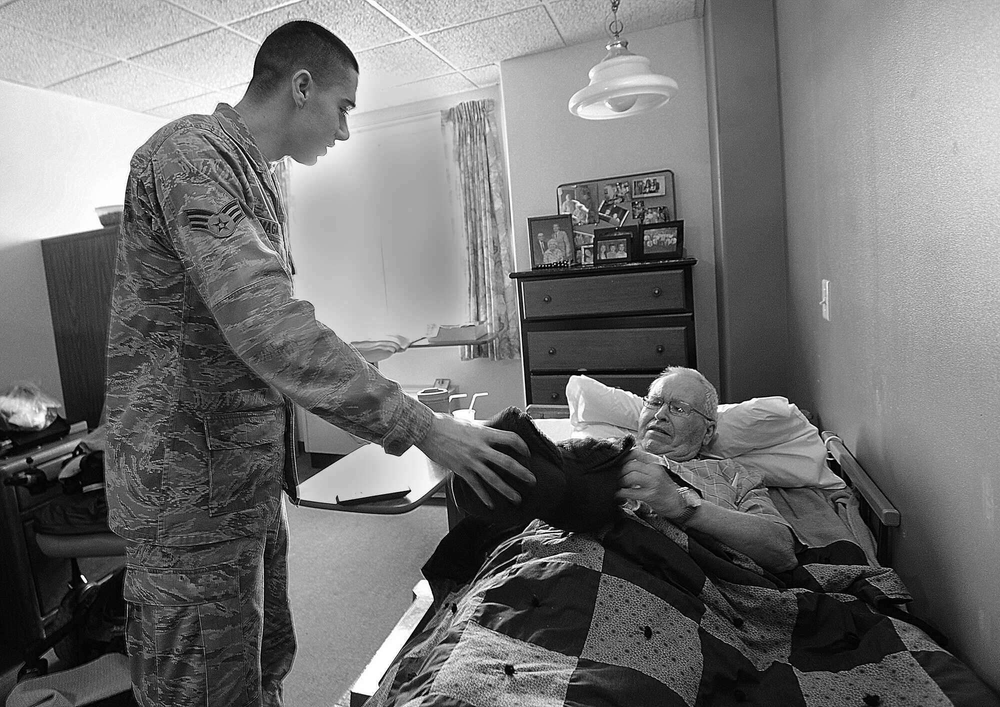 MINOT, N.D. -- Senior Airman Andrew Magathan, 791st Missile Security Forces
Squadron response force leader, presents a local veteran with a blanket as a
gift for his prior services to the country here, Mar. 1. Magathan and
members of his squadron visited Trinity Homes in Minot to donate blankets to
the veterans housed there. (U.S. Air Force photo/Senior Airman Jose L.
Hernandez)