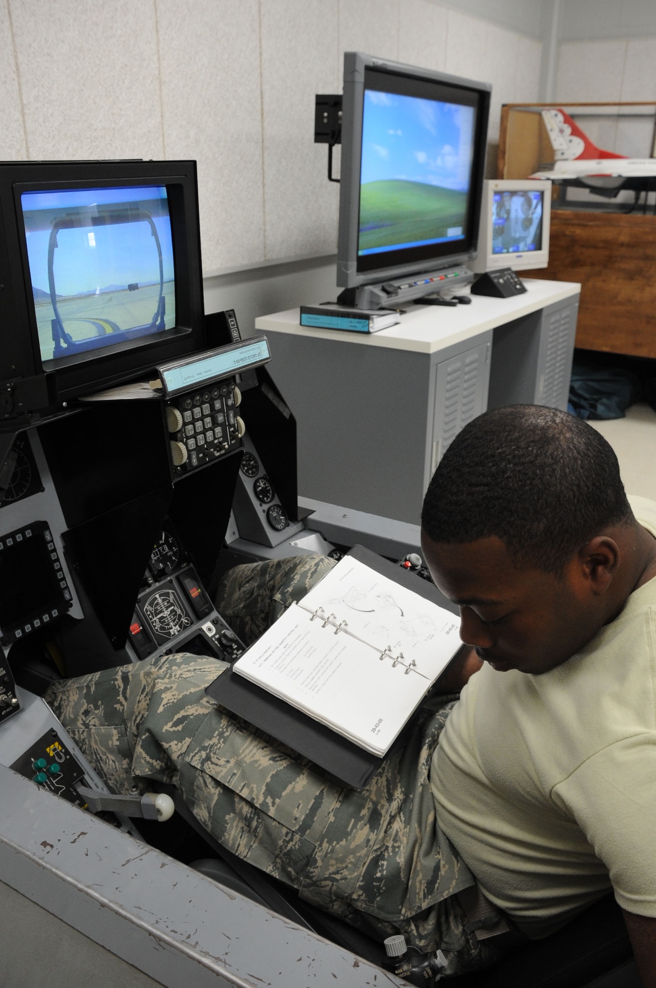 Airman Dantavious Hall, an F-16 avionics student in training from the 365th Training Squadron, practices flight checks in a cockpit simulator March 6, 2013. The cockpit gives students hands-on experience before they operate on the flightline. (U.S. Air Force photo by Airman First Class Jelani Gibson) 