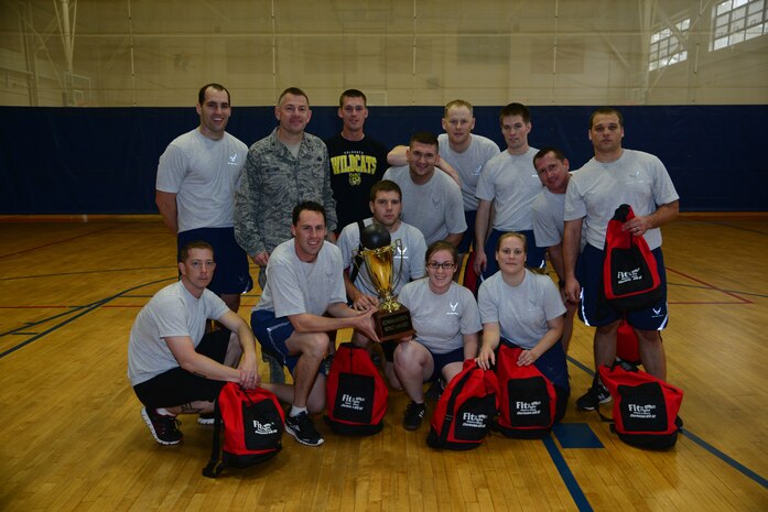 Airmen from the 628th Civil Engineer Squadron gather with Col. Richard McComb, Joint Base Charleston commander, after defeating the 628th Comptroller Squadron in the final game of the Commander's Fitness Challenge dodge ball tournament March 1, 2013, at the Fitness on Joint Base Charleston - Air Base, S.C. The Commander’s Challenge is held every quarter to provide friendly competition as well raise esprit de corps. (U.S. Air Force photo/Staff Sgt. Rasheen Douglas)