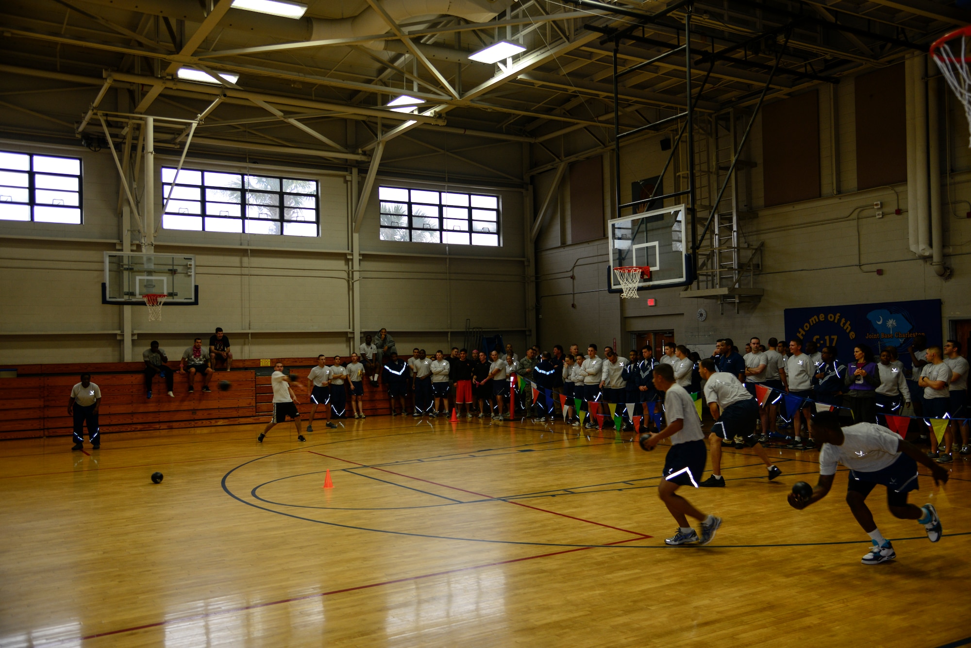 Airmen watch from the sidelines as dodgeball teams from the 628th Civil Engineer Squadron and 628th Comptroller Squadron face off during the Commander's Fitness Challenge dodgeball game March 1, 2013, at the Fitness Center on Joint Base Charleston - Air Base, S.C. The 628th CES won the tournament. (U.S. Air Force photo/Staff Sgt. Rasheen Douglas)