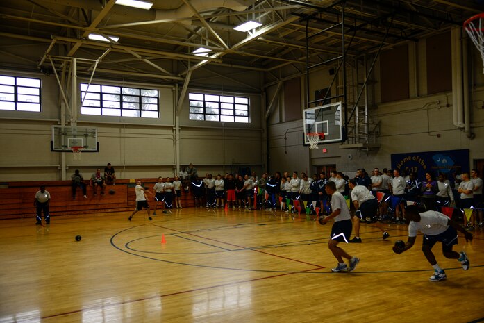 Airmen watch from the sidelines as dodgeball teams from the 628th Civil Engineer Squadron and 628th Comptroller Squadron face off during the Commander's Fitness Challenge dodgeball game March 1, 2013, at the Fitness Center on Joint Base Charleston - Air Base, S.C. The 628th CES won the tournament. (U.S. Air Force photo/Staff Sgt. Rasheen Douglas)