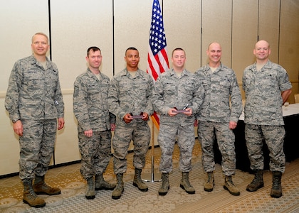 Colonel Darren Hartford 437th Airlift Wing commander (left), and Chief Master Sgt. Gerard Komen, 437th Maintenance Operations Squadron superintendent (right), recognize March's Diamond Sharp winners March 5, 2013, at the Charleston Club at Joint Base Charleston – Air Base, S.C. The Diamond Sharp recipients are (third and fourth from left) Airman 1st Class Gregory Foster, 437th Aerial Port Squadron passenger services agent and Senior Airman Joseph Shewmaker, 437th Operations Group knowledge operations manager. Pictured with the Diamond Sharp winners are Master Sgt. Jeremy Klemme, 437th APS first sergeant and Master Sgt. Brett Hopkins, 437th OG first sergeant. Diamond Sharp awardees are Airmen chosen by their first sergeants for their excellent performance. Not pictured here but also a recipient of this month's Diamond Sharp award are Airman 1st Class Cole Lane, 14th Airlift Squadron loadmaster and Staff Sgt. Lee Vearrier, 16th Airlift Squadron loadmaster evaluator special operations level II. (U.S. Air Force photo/Staff Sgt. Rasheen Douglas)