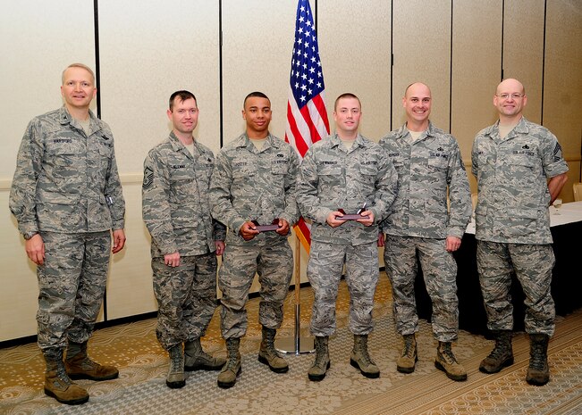 Colonel Darren Hartford 437th Airlift Wing commander (left), and Chief Master Sgt. Gerard Komen, 437th Maintenance Operations Squadron superintendent (right), recognize March's Diamond Sharp winners March 5, 2013, at the Charleston Club at Joint Base Charleston – Air Base, S.C. The Diamond Sharp recipients are (third and fourth from left) Airman 1st Class Gregory Foster, 437th Aerial Port Squadron passenger services agent and Senior Airman Joseph Shewmaker, 437th Operations Group knowledge operations manager. Pictured with the Diamond Sharp winners are Master Sgt. Jeremy Klemme, 437th APS first sergeant and Master Sgt. Brett Hopkins, 437th OG first sergeant. Diamond Sharp awardees are Airmen chosen by their first sergeants for their excellent performance. Not pictured here but also a recipient of this month's Diamond Sharp award are Airman 1st Class Cole Lane, 14th Airlift Squadron loadmaster and Staff Sgt. Lee Vearrier, 16th Airlift Squadron loadmaster evaluator special operations level II. (U.S. Air Force photo/Staff Sgt. Rasheen Douglas)