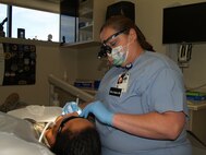 Ms. Mercy Padgett, Dental Hygenist at the 341st Medical Group works to ensure a Team Malmstrom members dental needs are met to ensure he is medically fit for duty.