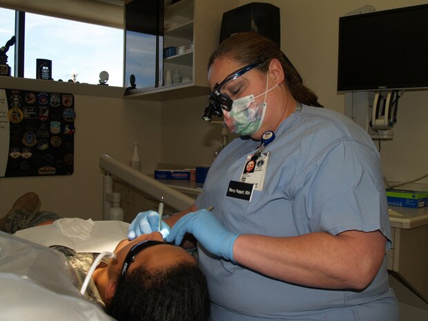 Ms. Mercy Padgett, Dental Hygenist at the 341st Medical Group works to ensure a Team Malmstrom members dental needs are met to ensure he is medically fit for duty.