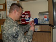 TSgt Duranti prepares to give an immunization to an eager beneficiary.