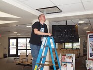 Mr. Hoy traces cable to the medical group lobby for a new digital signage program developed by 341st Medical Group Information Services Staff.  The new program will put vital health information in front of the beneficiary in every waiting area in the MDG.