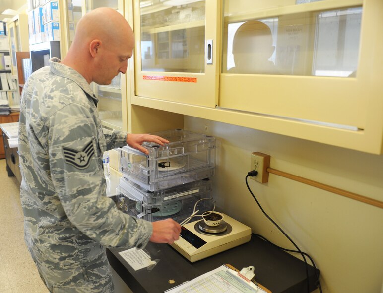 Staff Sgt. Paul Bauer, 9th Civil Engineer Squadron water and fuels system maintenance journeyman, measures the weight of a bio-solid at the waste water facility on Beale Air Force Base, Calif., March 5, 2013. The process helps determine the amount of bacteria removed from the solid. (U.S. Air Force photo by Airman 1st Class Bobby Cummings/Released)