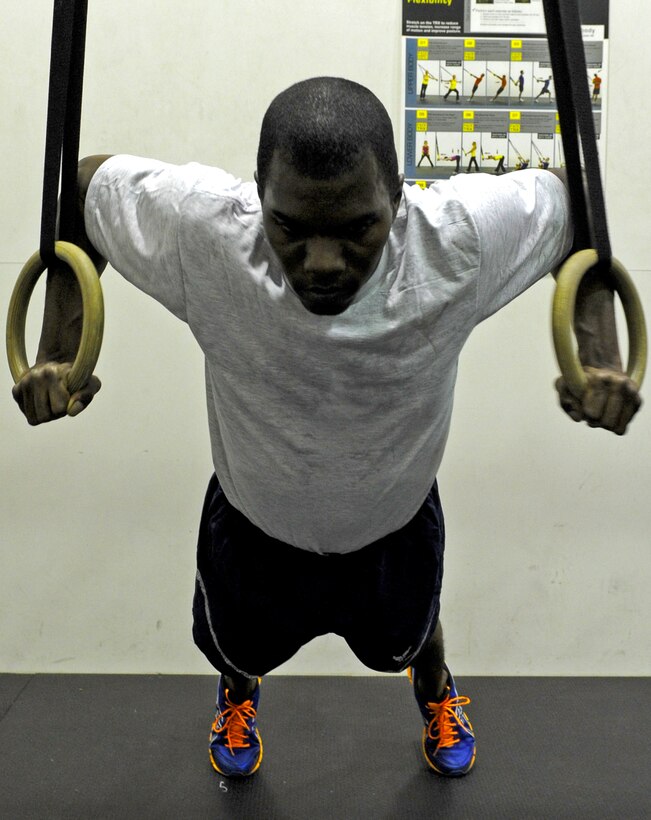 Senior Airman Charleston Boie, 7th Logistics Readiness Squadron, performs the second step of the Exercise of the week, the TRX Chest Press. (U.S. Air Force photo by Airman 1st Class Peter Thompson/ Released)