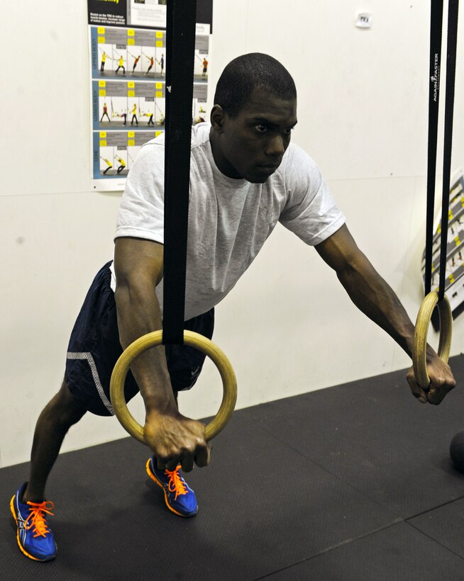 Senior Airman Charleston Boie, 7th Logistics Readiness Squadron, performs the first step of the Exercise of the week, the TRX Chest Press. (U.S. Air Force photo by Airman 1st Class Peter Thompson/ Released)