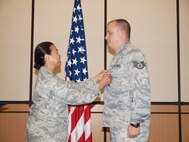 SSgt Bloomfield receives medal from his commander, Lt Col Editha Heberlein