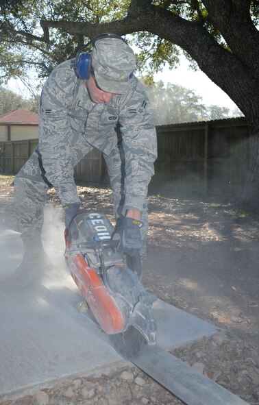 Airman 1st Class Cameron Kruell, 2nd Civil Engineer Squadron Heavy Repair Section, operates a K-12 saw to cut through excess concrete on Barksdale Air Force Base, La., March 6. Heavy repair Airmen, known as "Dirt Boys," use a variety of heavy equipment such as front-end loaders, bulldozers and backhoes to accomplish a number of tasks around the base. (U.S. Air Force photo/Airman 1st Class Benjamin Gonsier)
