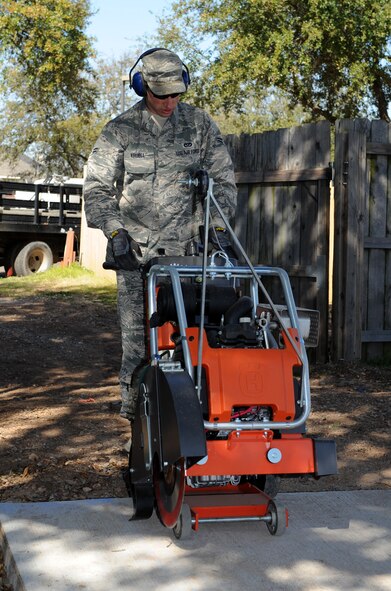 Airman 1st Class Cameron Kruell, 2nd Civil Engineer Squadron Heavy Repair Section, operates a walk behind saw on Barksdale Air Force Base, La., March 6. The saw is a heavy duty power tool used to cut through hard materials like concrete. (U.S. Air Force photo/Airman 1st Class Benjamin Gonsier)