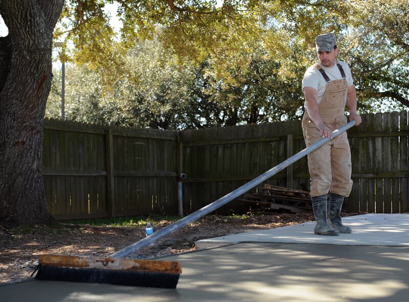 Staff Sgt. Kyle Pullum, 2nd Civil Engineer Squadron Heavy Repair Section, brooms freshly placed concrete on Barksdale Air Force Base, La., March 5. Pullum placed a nonskid finish on the concrete to prevent slipping. (U.S. Air Force photo/Airman 1st Class Benjamin Gonsier)