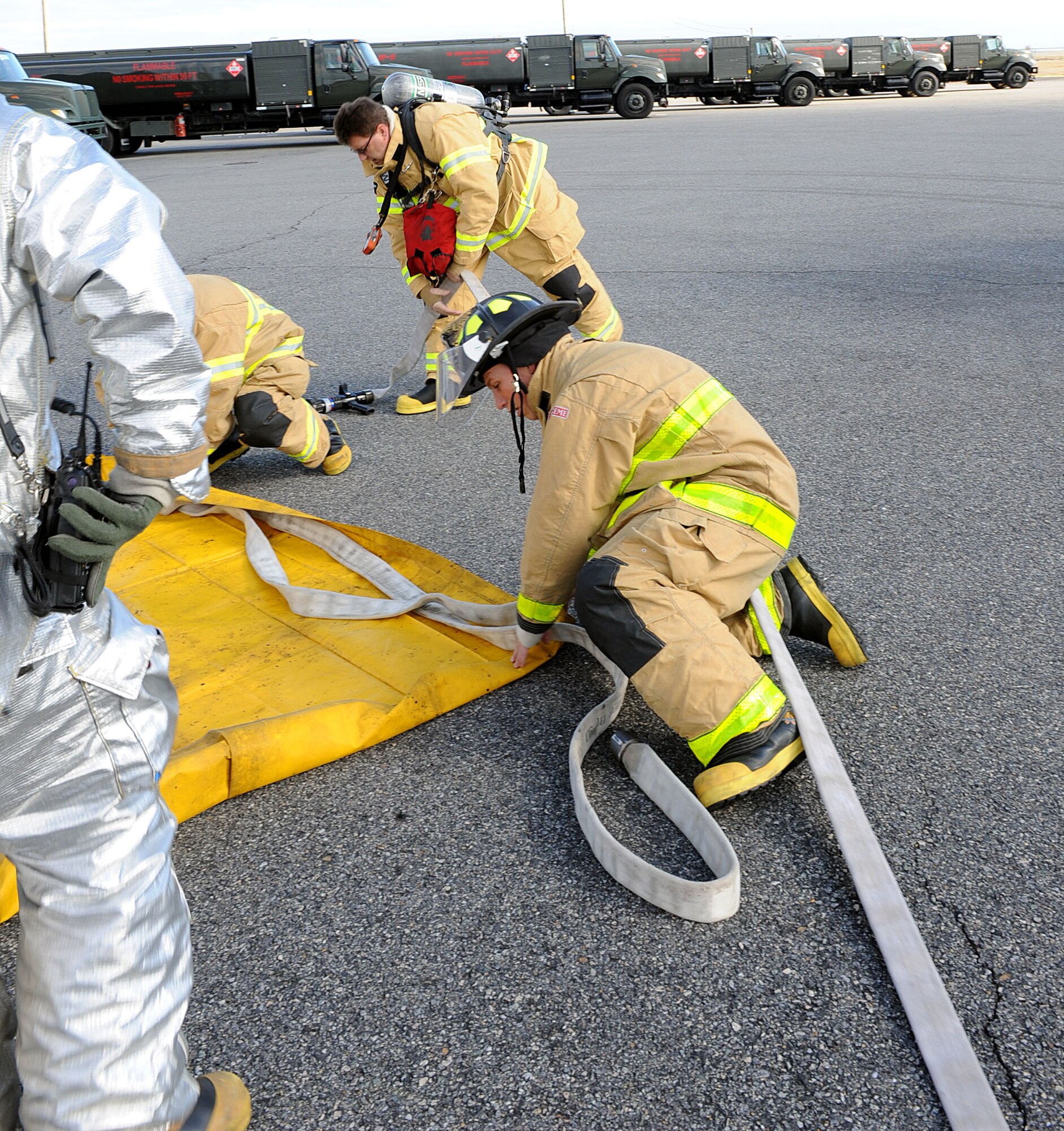 Members of the 633rd Civil Engineering Squadron prepare for a fuel spill exercise at Langley Air Force Base, Va., Feb. 28, 2013. Fuel spill exercises are performed to ensure that first-responders know what the appropriate steps are to contain a spill in a real world situation. (U.S. Air Force photo by Senior Airman Brittany Paerschke-O’Brien/ Released)