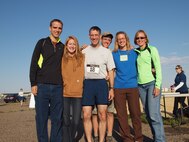 CMSgt Buchi poses with his family at a medical group sponsored fitness run.  CMSgt Buchi's family volunteered to support the event by helping with setup, passing out refreshments, and anything else that needed to be accomplished.
