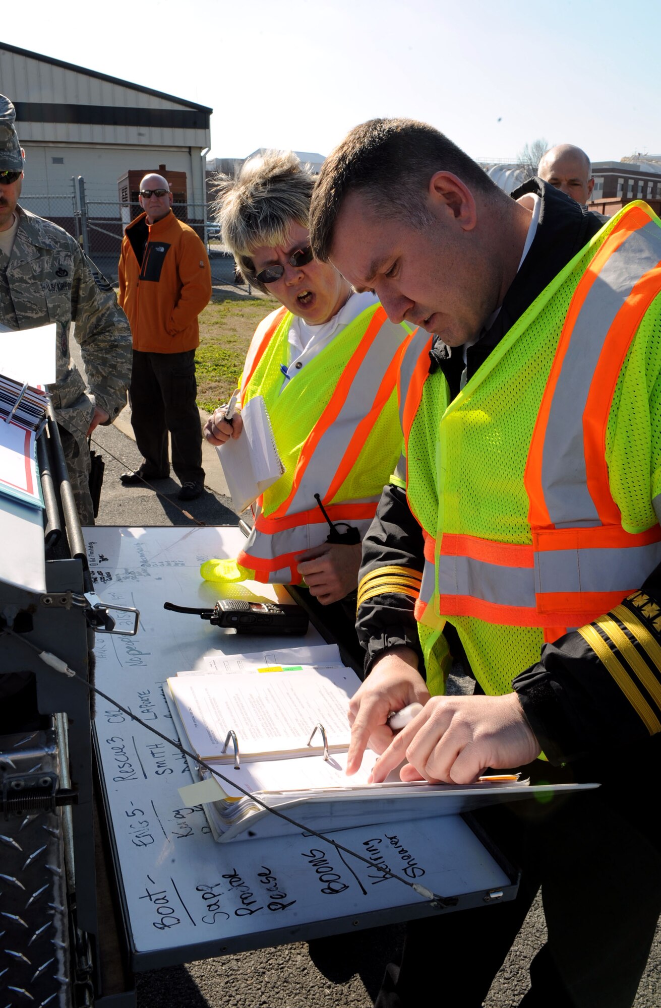 Members of the 633rd Civil Engineering Squadron establish a control center during a fuel spill exercise at Langley Air Force Base, Va., Feb. 28, 2013. Fuel spill exercises are conducted to observe emergency response teams as they assess the situation and contain the spill. (U.S. Air Force photo by Senior Airman Brittany Paerschke-O’Brien/ Released)