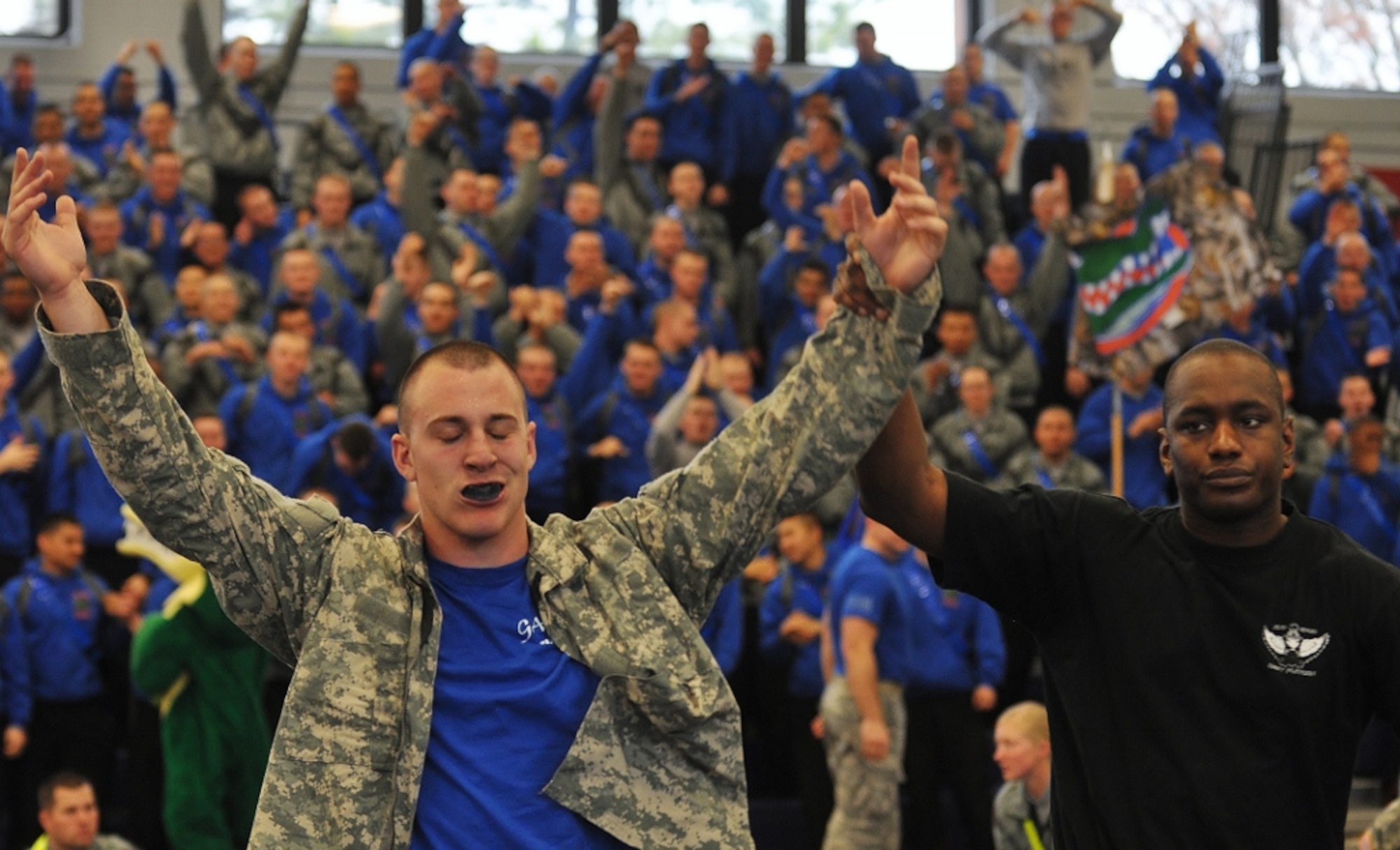An exhausted U.S. Army Pfc. Nick Reddell (left), assigned to A Company, is proclaimed the winner of the heavyweight class final match after he defeated D Co.'s Pvt. Kyle Post during the 1st Battalion, 222nd Aviation Regiment's biannual combatives tournament at Anderson Field House at Fort Eustis, Va., Feb. 23, 2013. Reddell's attributed his success in the tournament to his past as an amateur wrestler. (U.S. Air Force photo by Senior Airman Jason J. Brown/Released)