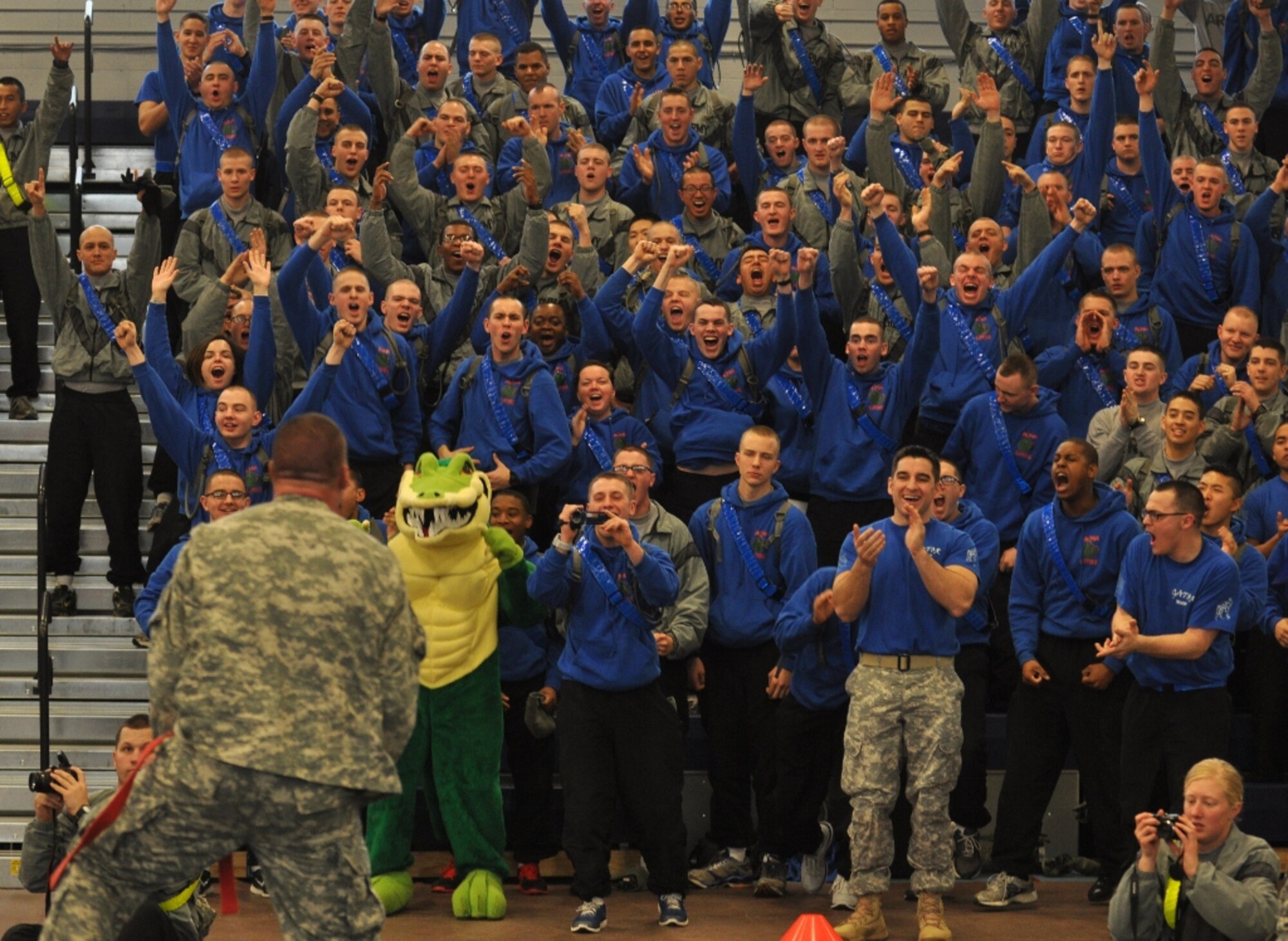 U.S. Army Pfc. Nick Reddell (left, facing crowd), assigned to A Company, rallies A Co.'s Soldiers after he defeated D Co.'s Pvt. Kyle Post in the heavyweight class final match during the 1st Battalion, 222nd Aviation Regiment's biannual combatives tournament at Anderson Field House at Fort Eustis, Va., Feb. 23, 2013. Despite Reddell's victory, D Co. won the tournament with 33 total points. (U.S. Air Force photo by Senior Airman Jason J. Brown/Released)