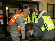 Medical Group triage team receives and processes a patient during a mass casualty exercise.