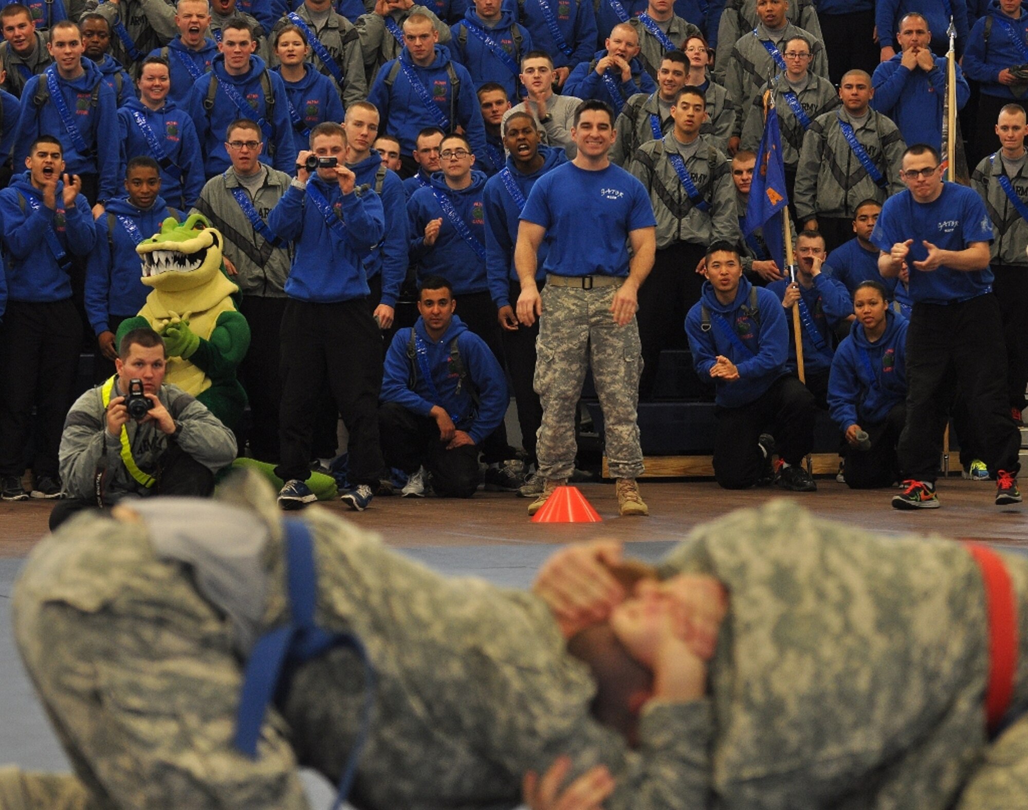 U.S. Army Soldiers from A Company watch as Pfc. Nick Reddell (bottom right), assigned to A Co., battles D Co.'s Pvt. Kyle Post in the heavyweight class final match during the 1st Battalion, 222nd Aviation Regiment's biannual combatives tournament at Anderson Field House at Fort Eustis, Va., Feb. 23, 2013. More than 1,200 Soldiers and guests, mostly Advanced Individual Training students from the battalion's five companies, packed the gymnasium to watch the tournament. (U.S. Air Force photo by Senior Airman Jason J. Brown/Released)