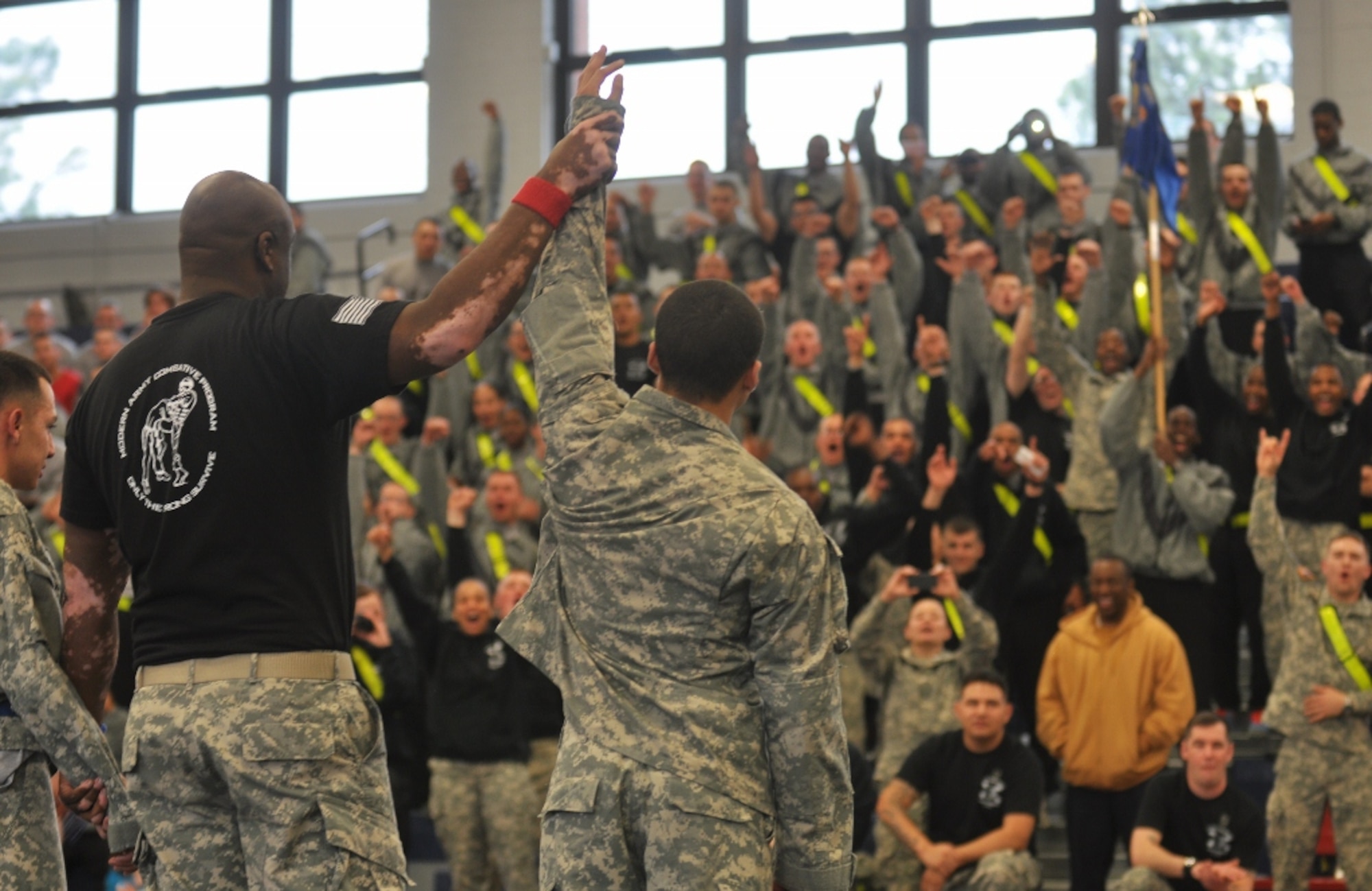 U.S. Army Soldiers from B Company cheer as U.S. Army Pvt. Sergio McCluskey (center), assigned to B Company, is announced as winner of the lightweight class final match during the 1st Battalion, 222nd Aviation Regiment's biannual combatives tournament at Anderson Field House at Fort Eustis, Va., Feb. 23, 2013. Soldiers from each of the battalion's five companies participate in the elimination-style tournament. (U.S. Air Force photo by Senior Airman Jason J. Brown/Released)