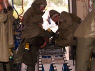 Volunteer patient, Grey Osment, is scrubbed of any possible contaminants during a medical group mass casualty exercise