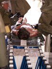 Grey Osment is prcoessed through the medical group's In-Place Patent Decontamination (IPPD) tent.  Grey, along with over 100 other Malmstrom personnel and family members voluteered to act as casualties in an all day mass casualty exerercise.  Grey is the son of Mr. John Osment, 341st Medical Group Chief Information Officer.
