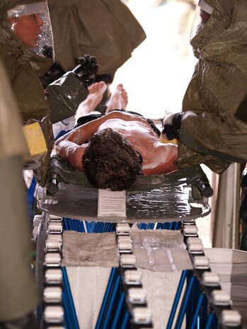 Grey Osment is prcoessed through the medical group's In-Place Patent Decontamination (IPPD) tent.  Grey, along with over 100 other Malmstrom personnel and family members voluteered to act as casualties in an all day mass casualty exerercise.  Grey is the son of Mr. John Osment, 341st Medical Group Chief Information Officer.