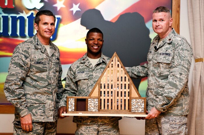 Col. Barry Cornish, 99th Air Base Wing commander, Maj. Julian Gaither and Maj. Kenneth Beale, 99th Air Base Wing chaplains, pose for a group photo during the national Prayer Breakfast March 1, 2013, at Nellis Air Force Base, Nev. Beale spoke about his experiences while being deployed and his calling as a chaplain in the U.S. Air Force. (U.S. Air Force photo by Airman 1st Class Jason Couillard)