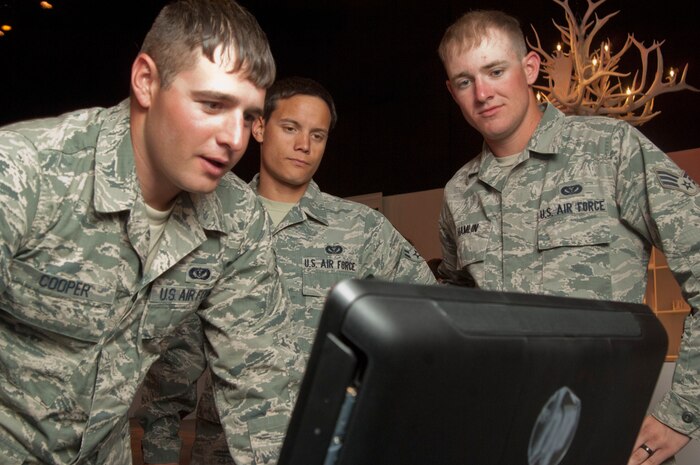 Senior Airman Lester Cooper, Airman 1st Class Jonathan Taka and Senior Airman Alexander Hamlin, 820th Red Horse construction equipment operators,  visit the Adopt A Serviceman website to sign up to become adopted service members March 2, at the Adopt a Serviceman event held at Silverton Hotel and Casino, Las Vegas, Nev. The AAS program initially was created to support military members who are deployed or about to be deployed. Its mission now is to reach all service members no matter if they’re deployed or at home station. (U.S. Air Force photo by Airman 1st Class Monet Villacorte)