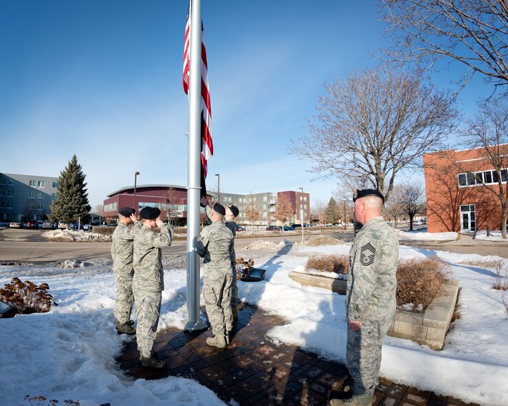 Chief Master Sgt. Jeffrey Imsdahl, Tech. Sgt. James Chadwick, Tech. Sgt. Ryan St. John, Staff Sgt. Benjamin Rosengarded, and Senior Airman Jennifer Heintz, 934th Security Forces Squadron, lower the flag during retreat at the Minneapolis-St. Paul Air Reserve Station, Minn.  (U.S. Air Force photo/Shannon McKay)934th Security Forces Squadron lower the flag during retreat at the Minneapolis-St. Paul Air Reserve Station, Minn.  (U.S. Air Force photo/Shannon McKay)