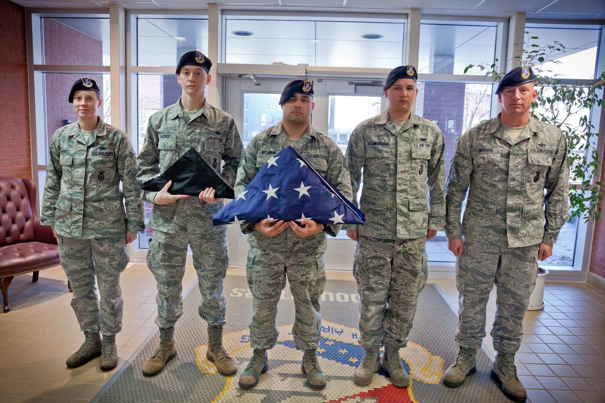 (Left to right) Senior Airman Jennifer Heintz, Tech. Sgt. James Chadwick, Tech. Sgt. Ryan St. John, Staff Sgt. Benjamin Rosengarded, and Chief Master Sgt. Jeffrey Imsdahl, 934th Security Forces Squadron, lower the flag during retreat at the Minneapolis-St. Paul Air Reserve Station, Minn.  (U.S. Air Force photo/Shannon McKay)