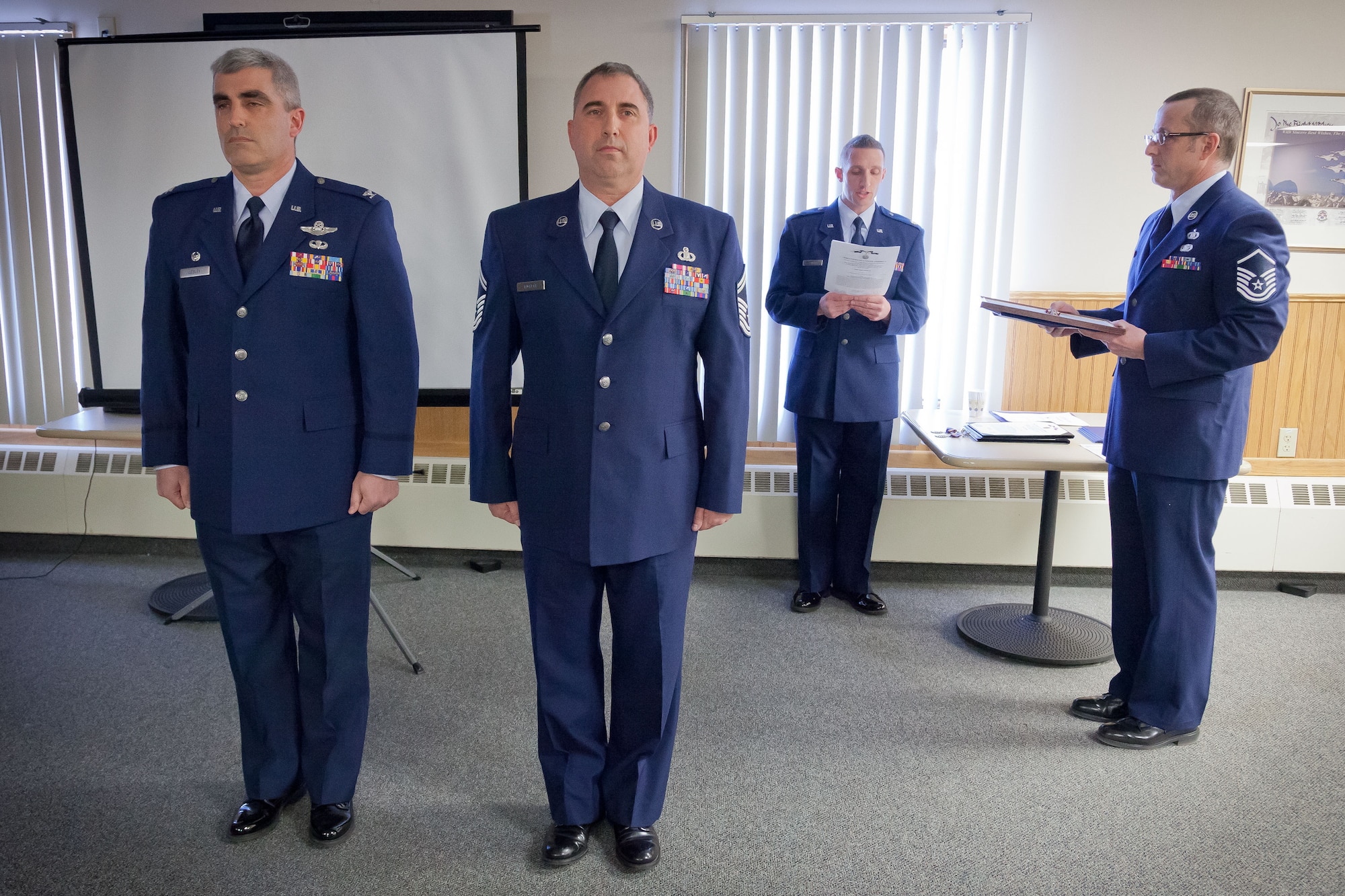 Col. Keith T. Wesley, 934th Operations Group commander, presents Senior Master Sgt. Troy P. Puckett with his Meritorious Service Medal at the group's Commander's Call during the March Unit Training Assembly.  (U.S. Air Force photo/Shannon McKay)