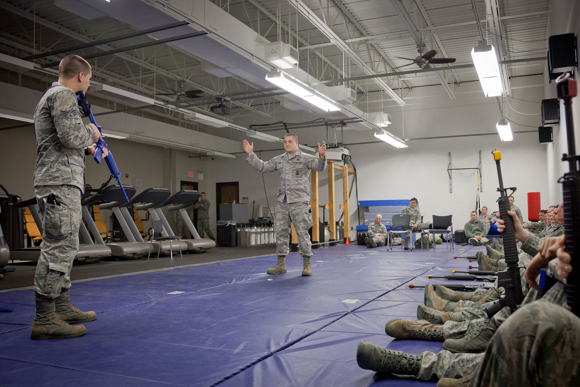 Senior Airmen Patrick McCarthy and Daniel Dewey, 934th Security Forces Squadron, demonstrate challenge procedures to members of the 934th Airlift Wing.  The weapons issue and clearing training class was held in preparation for the upcoming Operations Readiness Exercise in April.  (U.S. Air Force photo/Shannon McKay)