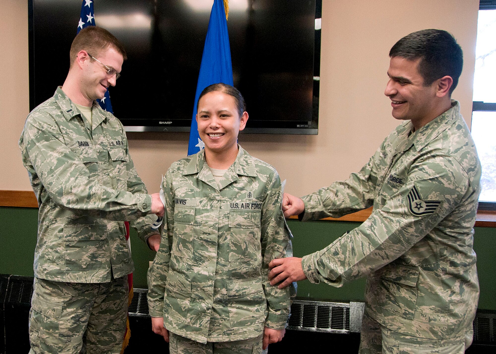 HANSCOM AIR FORCE BASE, Mass. -- Newly selected Senior Master Sgt. Erin Davis, from the 66th Medical Squadron, gets her stripes pinned on by 1st Lt. Donald Davison and Staff Sgt. Phillip Baiao during the Senior Master Sergeant Promotion Release Celebration at the Minuteman Commons Feb. 28. (U.S. Air Force photo by Mark Wyatt)