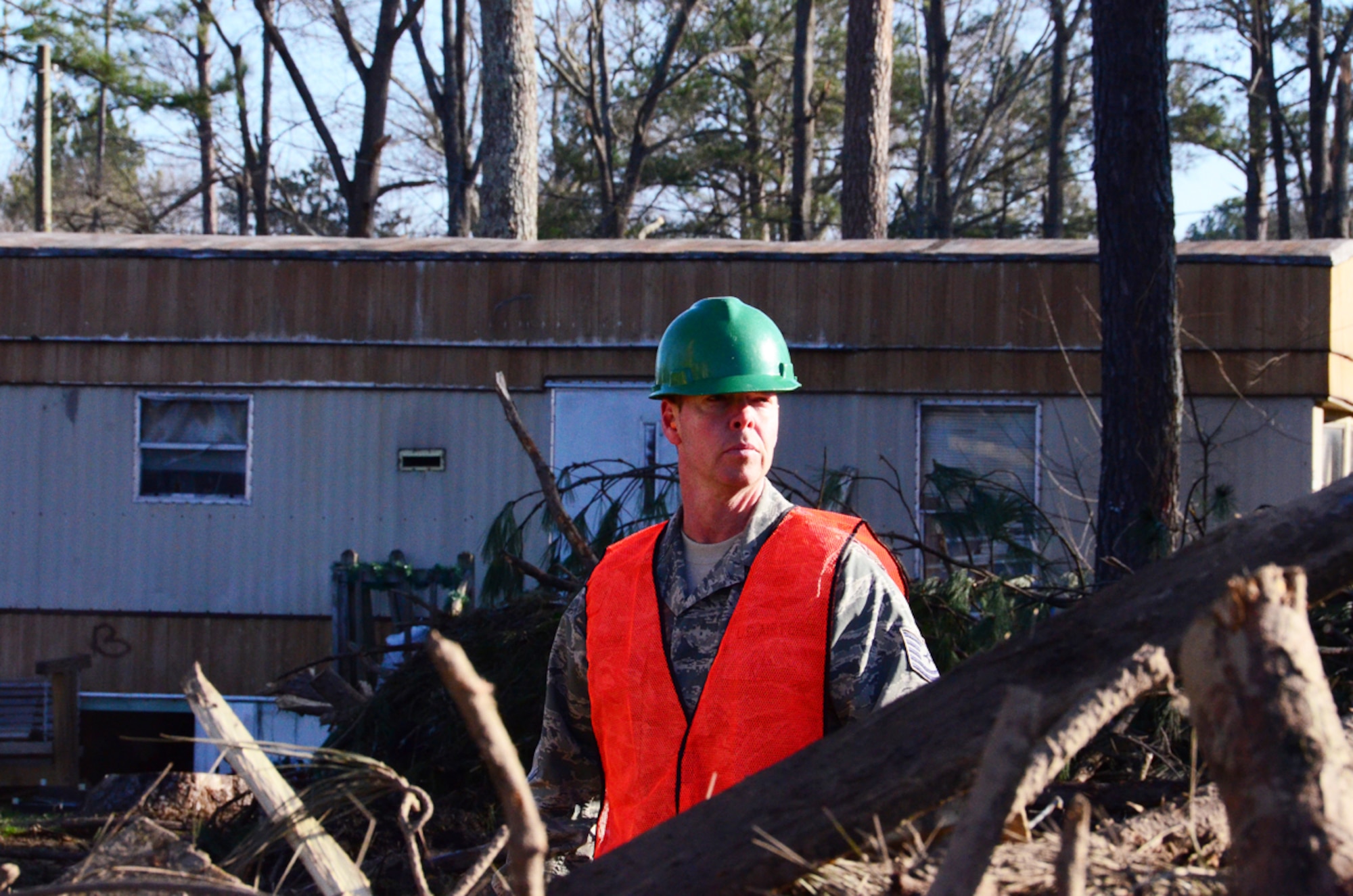 Tech. Sgt. Preston Caldwell of the 94th Operations Support Squadron assists residents of recently tornado-stricken Adairsville, Ga. with post storm clean-up Jan. 30. Downing and other volunteers cut down and cleared more than twelve damaged trees. (photos by Senior Airman Elizabeth Van Patten)