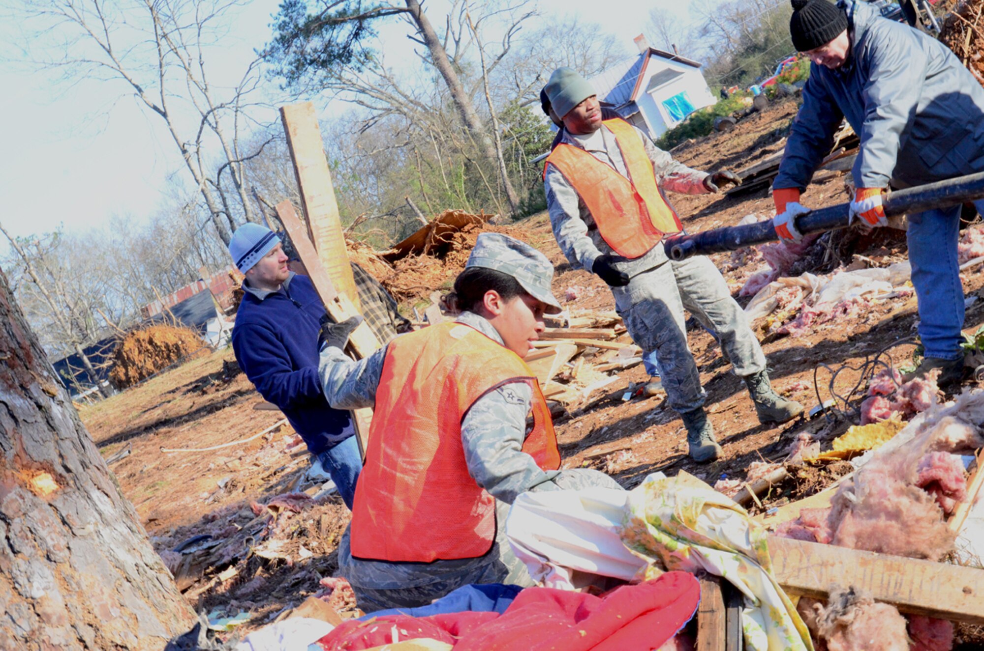Tech. Sgt. Dallas Criswell and Airman Jade Orr-Martin of the 94th Operations Support Squadron, and volunteer coordinators from Team Rubicon assist residents of recently tornado-stricken Adairsville, Ga. with post storm clean-up Jan. 30. The volunteers cut down and cleared more than twelve damaged trees. (photos by Senior Airman Elizabeth Van Patten)