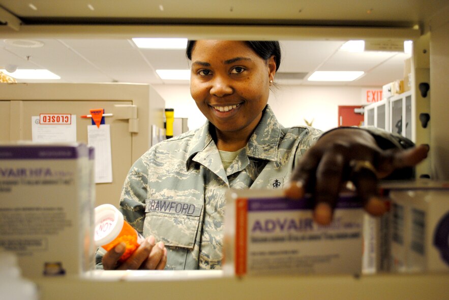 Tech. Sgt. Markiesha Crawford, 319th Medical Support Squadron NCO in charge of the pharmacy flight, organizes a shelf of medicine March 4, 2013, at the medical clinic on Grand Forks Air Force Base, N.D.  Crawford attended technical school training at Sheppard Air Force Base, Texas, for 11 weeks in order to become a pharmacy technician. (U.S. Air Force photo/ Staff Sgt. Luis Loza Gutierrez)