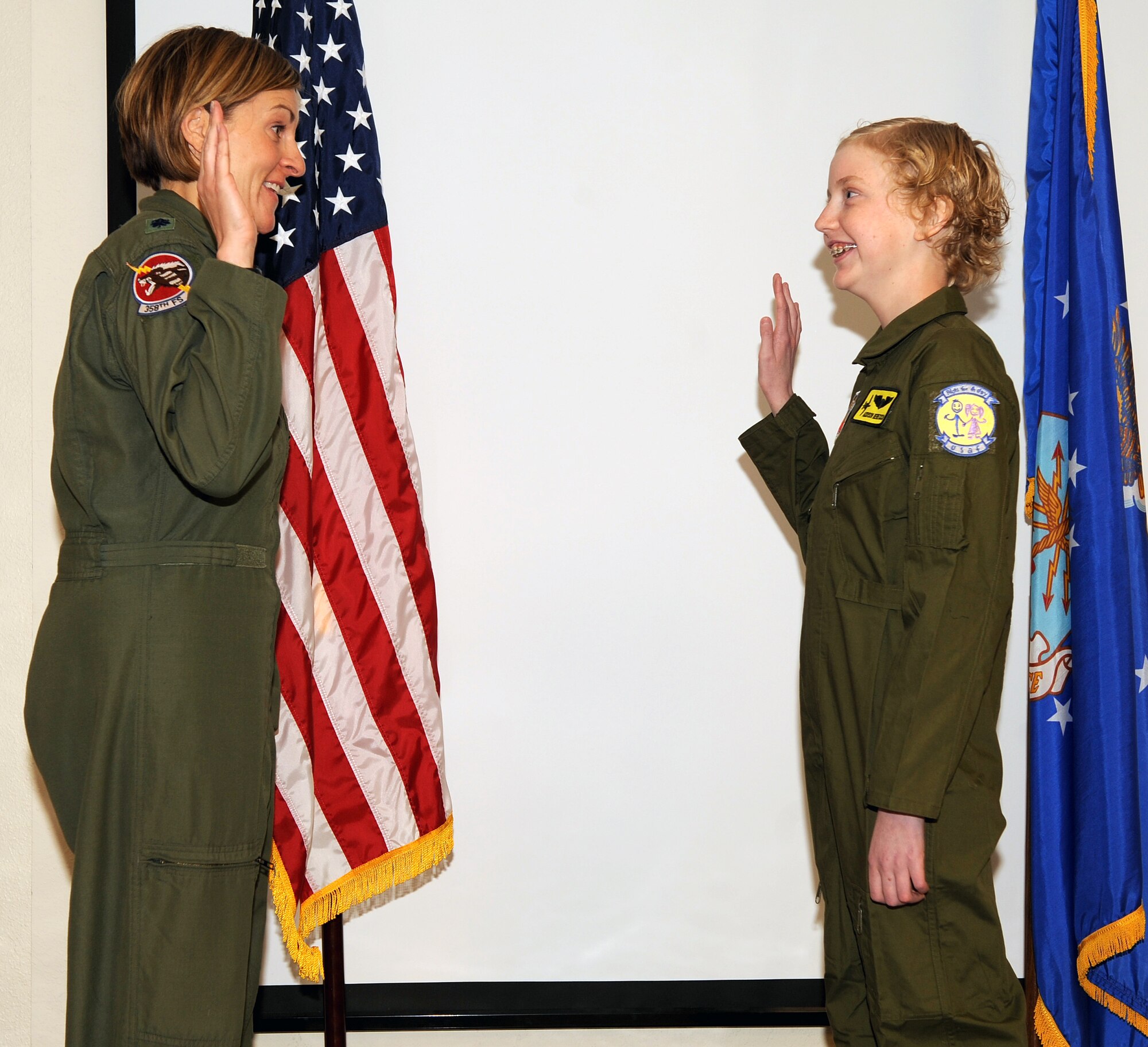 U.S. Air Force Lt. Col. Jennifer Short, 358th Fighter Squadron commander, swears in Addison Rerecich, a 13-year-old Tucsonan recovering from a double lung transplant, as part of the Pilot for a Day program at Davis-Monthan Air Force Base, Ariz. Feb. 21, 2013. The Pilot for a Day program begins with a brief "swearing in" ceremony at the host flying squadron, after which the child becomes an "honorary United States Air Force pilot". (U.S. Air Force photo by Senior Airman Brittany Dowdle)