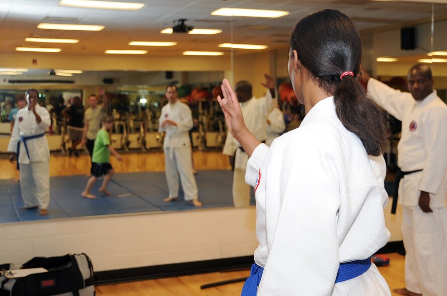 Students watch as their instructor, Lt. Col. John Lofton, Air Force Global Strike Command, shows them the proper form of a defense strike during a Hapkido class at the Fitness Center on Barksdale Air Force Base, La., March 1. More than 15 students attended the class, varying from active duty members, to spouses and children of various ages. (U.S. Air Force photo/Staff Sgt. Amber Ashcraft)
