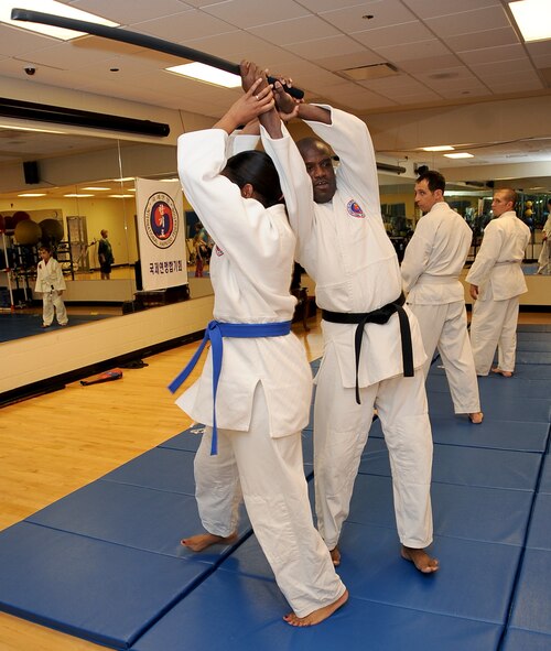 Lt. Col. John Lofton, Air Force Global Strike Command, acts as an attacker as his wife, Lillian, defends herself during a Hapkido class at the Fitness Center on Barksdale Air Force Base, La., March 1. Lofton, who has studied martial arts for more than 25 years, teaches the Korean art form three times a week. (U.S. Air Force photo/Staff Sgt. Amber Ashcraft)