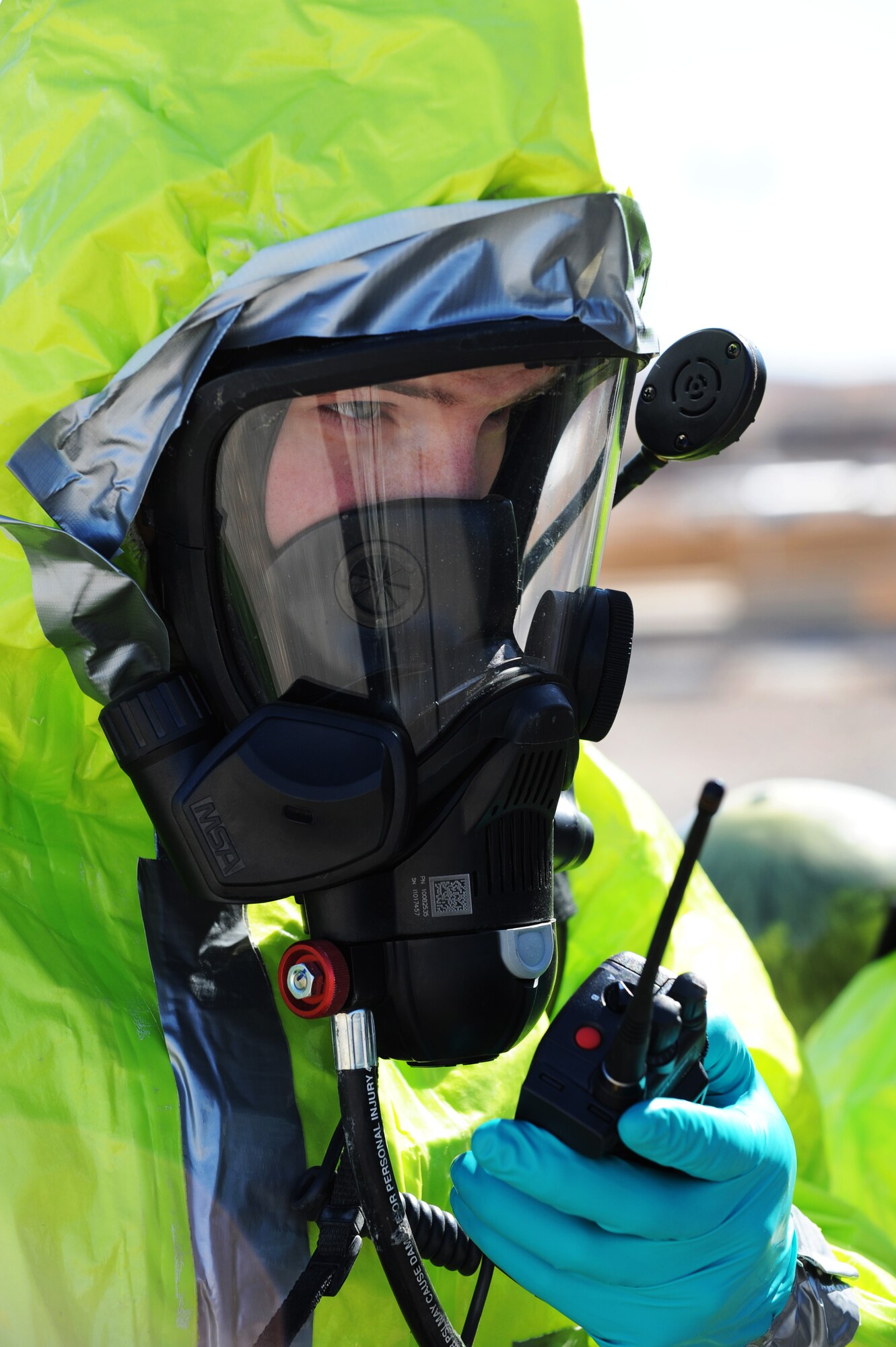 Senior Airman Nicholas Johnson, 99th Medical Group, bioenvironmental engineer journeymen, relays information about a chemical spill to his command during a simulated hazardous material incident Feb. 28, 2013 at Nellis Air Force Base, Nev. Johnson and other emergency responders report data as they discover it to ensure accurate information is passed to the incident commander. (U.S. Air Force photo by Staff Sgt. William P. Coleman)  


