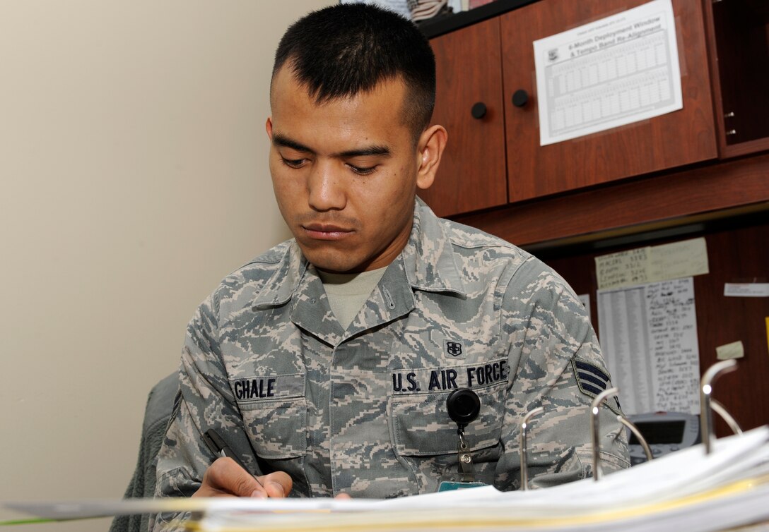 Senior Airman Tilli Ghale, 28th Medical Group unit deployment manager, updates a deployment checklist in a continuity binder at the 28th MDG on Ellsworth Air Force Base, S.D., March 4, 2013. Ghale received a 94 percent on his "Health Services Management" five-level Career Development Course – the highest score in the Air Force for that particular CDC in three years. (U.S. Air Force photo by Airman 1st Class Ashley J. Thum/Released)
