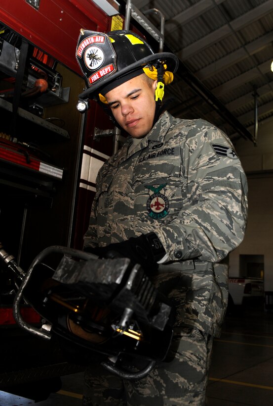 Senior Airman Brandon Stout, 28th Civil Engineer Squadron Fire Department driver operator, performs a daily damage check on a Jaws of Life tool from one of the fire trucks in the 28th CES Fire Department garage at Ellsworth Air Force Base, S.D., March 5, 2013. Stout has completed five-level Career Development Courses for his position, and recently received a 100 percent on the first of his seven-level courses, "Fire Instructor I." (U.S. Air Force photo by Airman 1st Class Ashley J. Thum/Released)