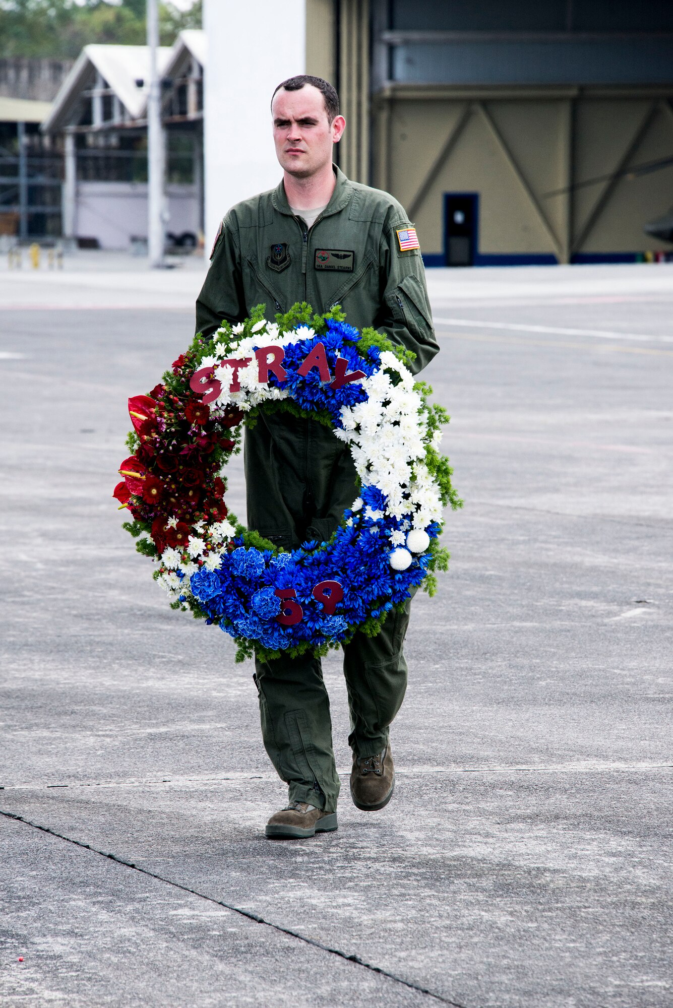 U.S. Air Force Senior Airman Dan Stearns, 1st Special Operations Squadron Loadmaster, carries a wreath that will be dropped from a U.S. Air Force MC-130H Combat Talon II special operations aircraft to memorialize Stray 59 Feb. 26, 2013. Stray 59 was a 1st Special Operations Squadron U.S. Air Force  MC-130E Combat Talon I special operations aircraft that went down in 1981 over Subic Bay, Phillippines during a training mission. (U. S. Air Force photo/Tech. Sgt. Kristine Dreyer)

