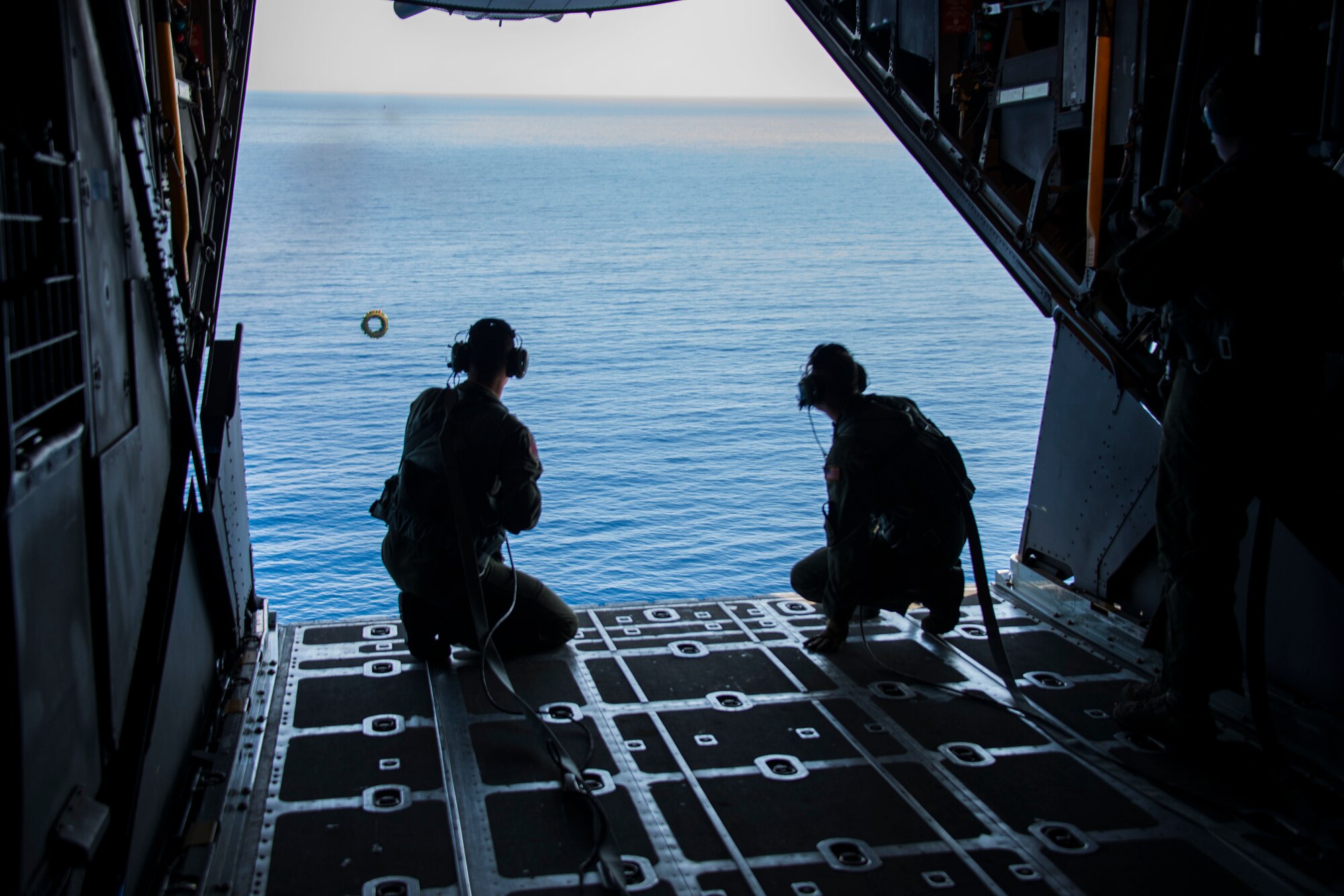 U.S. Air Force Staff Sgt. Zach Kelhi and Senior Airman Dan Stearns, 1st Special Operations Squadron Loadmasters, drop a wreath to memorialize Stray 59 over Subic Bay, Philippines, Feb 26, 2013. Stray 59 was a 1st Special Operations Squadron U.S. Air Force MC-130E Combat Talon I special operations aircraft that went down in 1981 over Subic Bay, Philippines, during a training mission. (U. S. Air Force photo/Tech. Sgt. Kristine Dreyer)