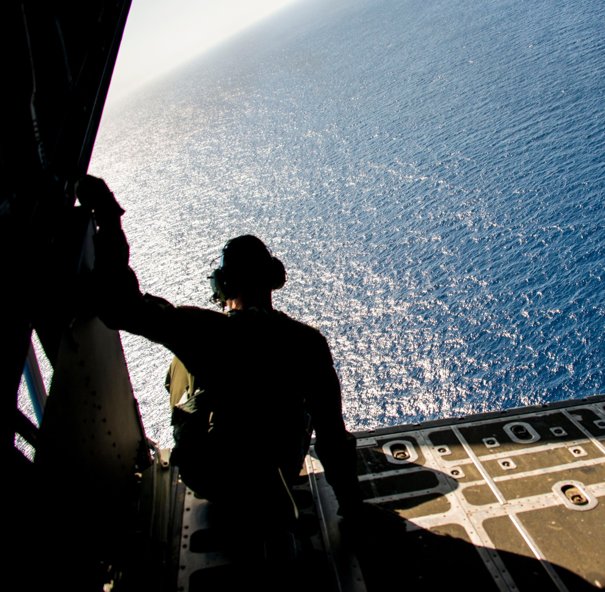 U.S. Air Force Senior Airman Dan Stearns, 1st Special Operations Squadron Loadmaster, sits on the back of a U.S. Air Force MC-130H Combat Talon II special operations aircraft over Subic Bay, Philippines, Feb 26, 2013. Stray 59 was a 1st Special Operations Squadron U.S. Air Force MC-130E Combat Talon I special operations aircraft that went down in 1981 over Subic Bay, Philippines, during a training mission. (U. S. Air Force photo/Tech. Sgt. Kristine Dreyer)