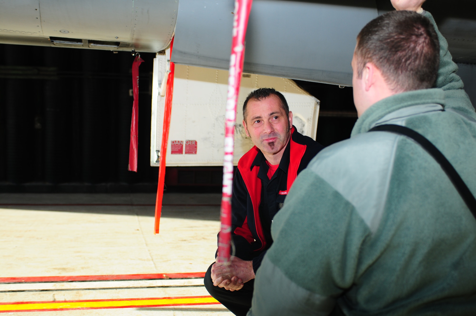 ROYAL AIR FORCE LAKENHEATH, England -- Staff Sgt. Paul Brown (right), 48th Civil Engineer Squadron firefighter crew chief, discusses aircraft safety hazards with Steve Bartrum, Norfolk Fire and Rescue Service watch manager, March 4, 2013. The Norfolk Fire and Rescue Service brigade received training on aircraft safety specific to firefighters such as engine shut down and pilot egress. (U.S. Air Force photo by Airman 1st Class Dana J. Butler)
